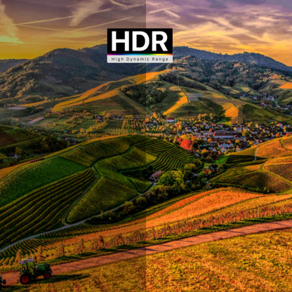 Hilly landscape with fields and a village, showcasing HDR effect.
