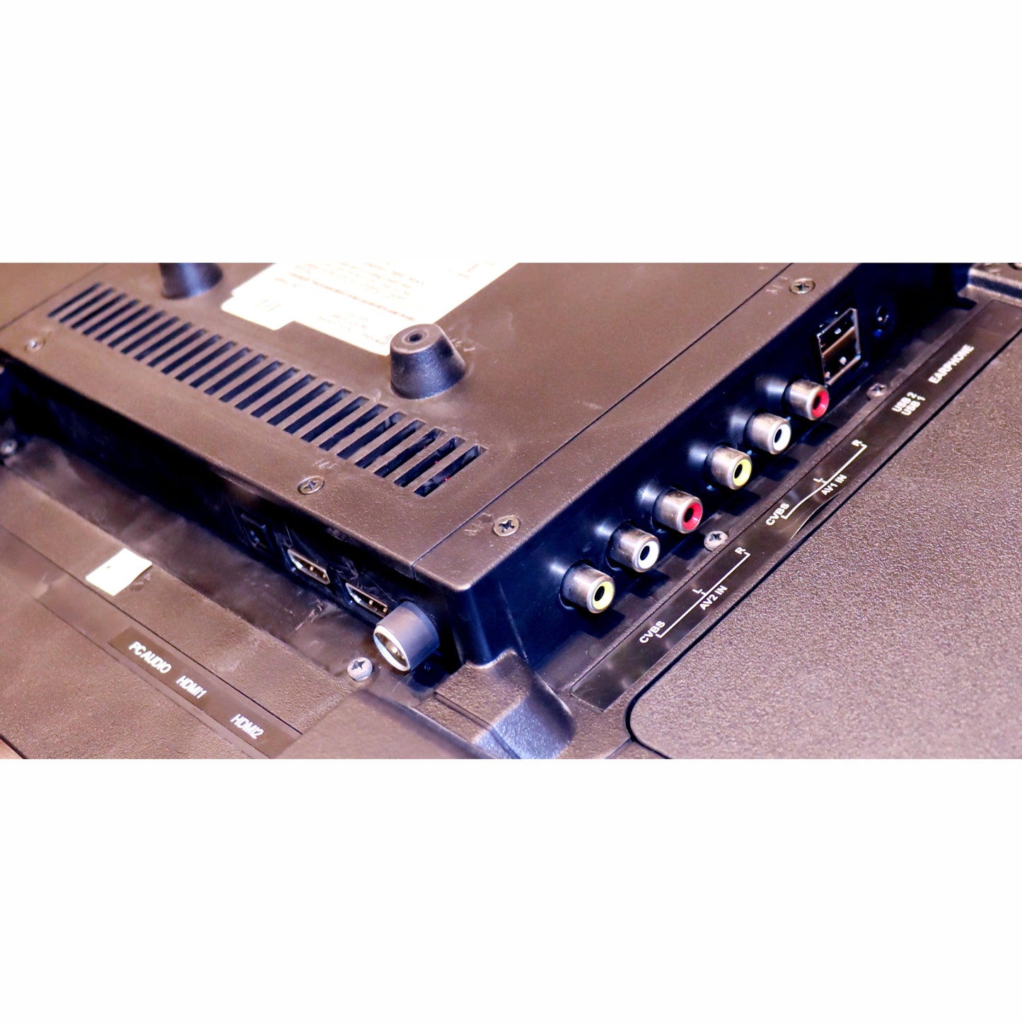 Close-up of an electronic device with connectors and labels on a white background