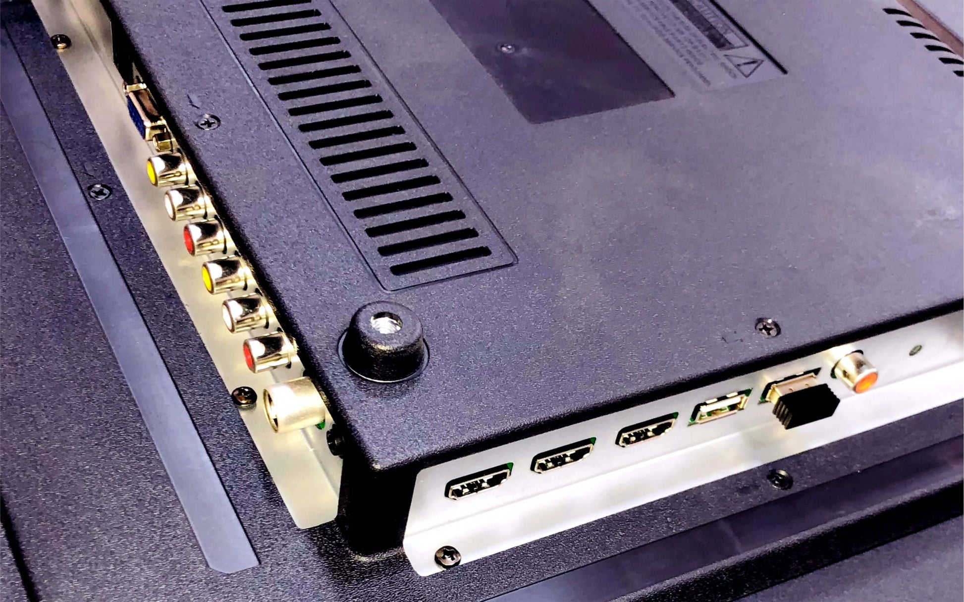 Back view of electronic equipment with ports and connectors.